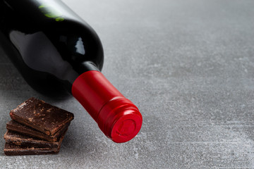 Wine and chocolate on concrete background. Copy Space.