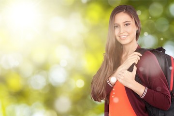 Young smilling female college student with backpack