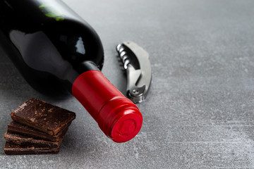 Wine and chocolate on concrete background. Copy Space.