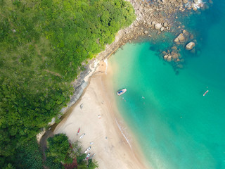 Aerial view of an amazing white sandy beach with turquoise water in tropical country. Amazing top view of sandy tropical beach. holiday destination. Palm and tropical beach with crystal clear water.