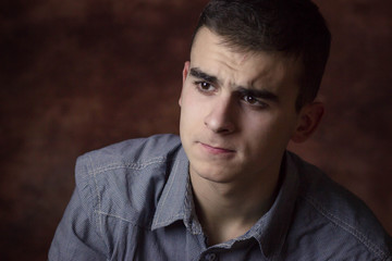 Young man being upset, worried. Human facial expression, body language