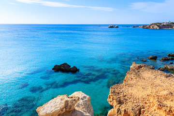 Fototapeta na wymiar Rocks and azure sea in beautiful bay on Karpathos island in Ammopi village, Greece