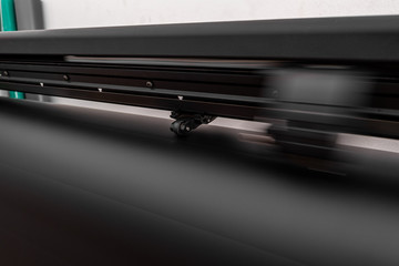 Obraz premium Vinyl cutter plotter machine and moving cutting head