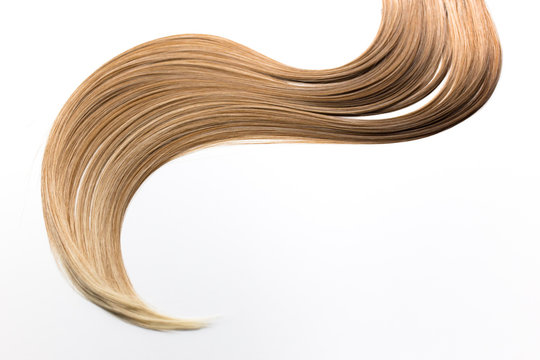 Piece of blonde hair on white isolated background. Hair care, healthy hair