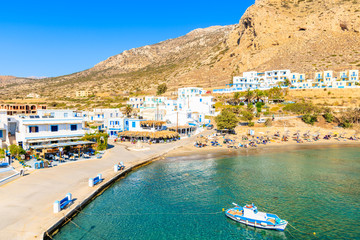 Fishing boat in picturesque Finiki port with mountains in background, Karpathos island, Greece