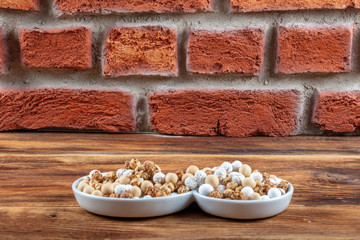 Roasted chickpeas in white cup on hardwood.The Turkish name is leblebi.