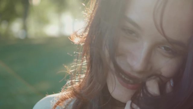 Beautiful cute young woman student enjoying nature in spring park, Happy Beautiful girl in Garden Slow motion video portrait of fashion girl.