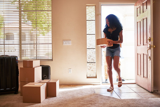 Interracial Couple Moving Into New House With Boxes