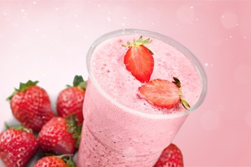 Glass of strawberry smoothie on wooden table