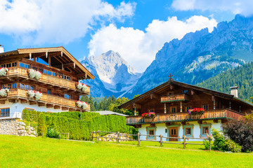Traditional alpine houses in village of Going am Wilden Kaiser on beautiful sunny summer day, Tirol, Austria - obrazy, fototapety, plakaty