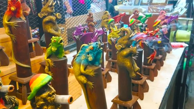 CHIANG MAI, THAILAND - MAY 2, 2019: The fuming incense censers on the counter of stall in Night Bazaar in shape of animals, birds and mythic creatures, on May 2 in Chiang Mai