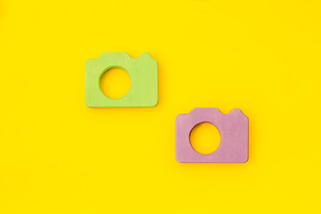 Blogger concept with photo camera on yellow background top view mockup