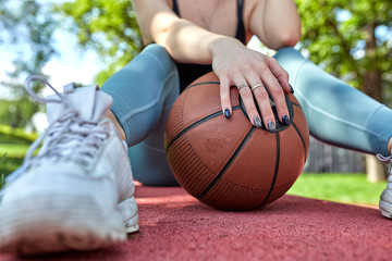 Beautiful sexy fitness girl in black sport wear with perfect body with basket ball at basketball...