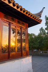 Old historical china culture wooden pavilion in Tiger Hill park in China, Suzhou with reflected sun light on sunset