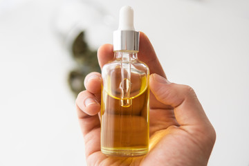bottle of Cannabis oil in pipette in hand, medical marijuana concept, close up, CBD cannabis OIL....