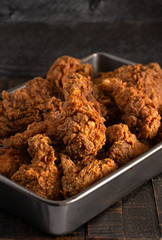 Batch of Crispy Homemade Fried Chicken on a Rustic Wooden Table