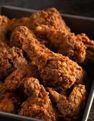 Batch of Crispy Homemade Fried Chicken on a Rustic Wooden Table