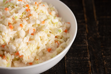 Bowl of Coleslaw on a Rustic Wooden Table