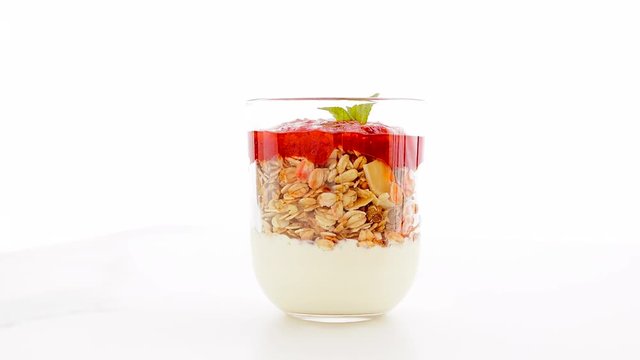 Homemade granola parfait with strawberry jam and mint, yogurt and muesli for healthy breakfast in the morning