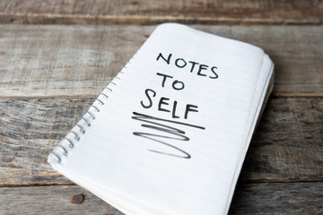 Notes to self words written with black marker on  notebook
