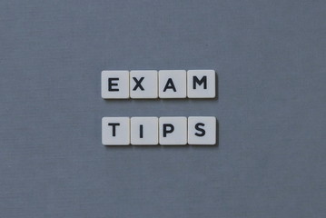 ' Exam Tips ' word made of square letter word on grey background.