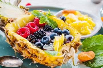Stuffed pineapple with wild berries and yogurt