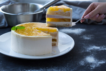Mango fruit Mousse Cake, decorated with fresh fruits in jelly. Whipped cheese with biscuits