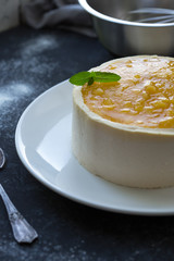 Mango fruit Mousse Cake, decorated with fresh fruits in jelly. Whipped cheese with biscuits