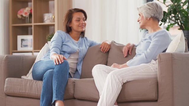 Family, Generation And People Concept - Happy Smiling Senior Mother Talking To Adult Daughter At Home