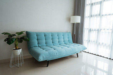 comfortable sofa in the living room beside the window