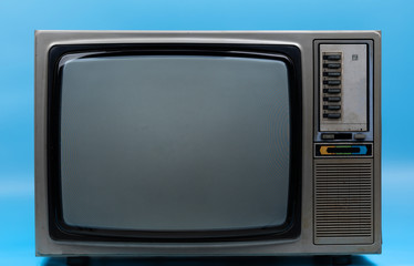 Vintage TV isolated on blue background .