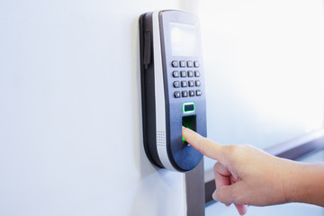 The employee scanning fingerprint to record working time