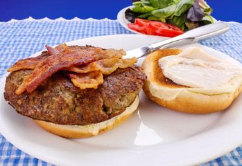 Ingredients for turkey burger with bacon and lettuce, tomatoes and mayonnaise.