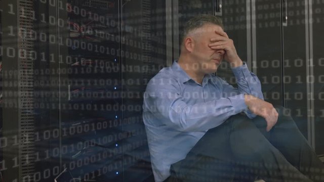Digital composite of a stressed technician in a server room