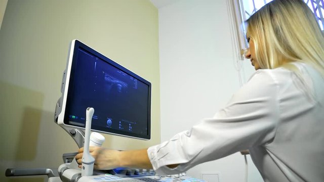 Doctor Taking A Sonogram on ultrasound machine