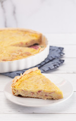 A Slice of Classic Quiche Lorraine on a Wooden Table
