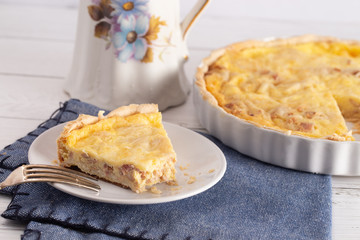A Slice of Classic Quiche Lorraine on a Wooden Table