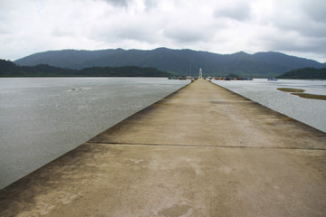 Cement jetty bridge stretches to the sea. Used for the docking of ships, after finding out the fish.