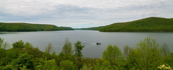 The Allegheny Reservoir in Warren County, Pennsylvania, USA behind Kinzua Dam on a spring day with a houseboat on the water