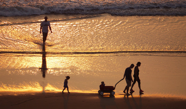 Silhouettes of people on the beach