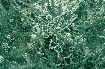 Texture abstract closeup background ice with grooves, furrows, and bubbles of air cought by frost in the mass of water while freezing