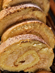 Slice rolled biscuit cake with cream for breakfast dessert close up. Limitations for diabetics.