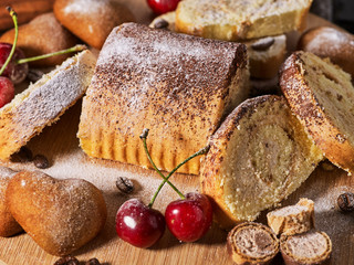 Cookies heart shape, sand rolled biscuit and cinnamon stick on wood table served dessert spoon at kitchen in rustic style. Morning sun flare. Dietary and non-fat product.