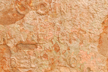 Brightly corroded metal sign with raised lettering.