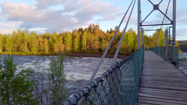 Suspension bridge on Glomma River in the forest in Hedmark county in Norway