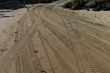 Four wheel drive tyre marks in sand background
