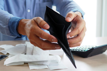 Man's hands open empty purse. Poverty, debt and bankruptcy in the payment of bills and credit...