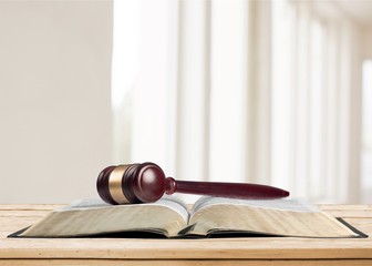 Book and wooden gavel on table. Justice concept