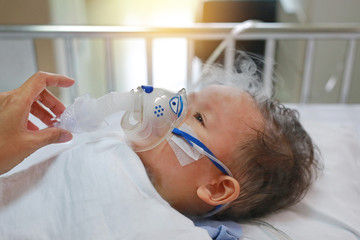 Baby has asthma and need nebulizations, Sick boy inhalation therapy by the mask of inhaler. Baby...