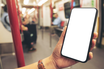 Mockup image of woman's hands holding black mobile phone with blank screen in subway